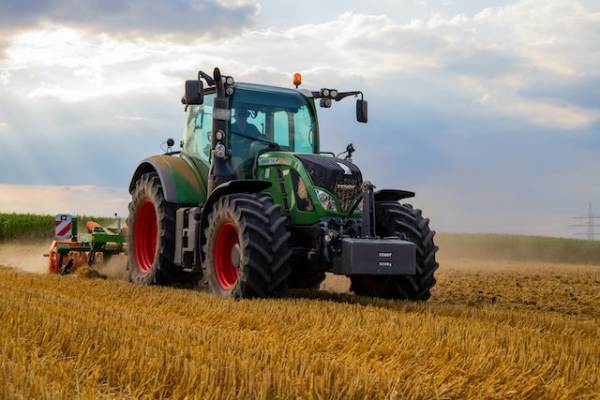 Agricultural and Farming: Farmers using advanced machinery in agricultural farming fields.