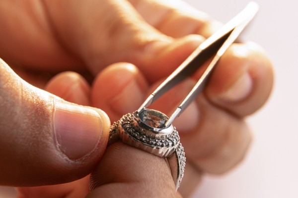 Custom Jewelry Designer: Jewelry designer crafting custom jewelry in a studio.